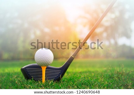 Golf balls on the golf course with golf clubs ready for golf in the first short.\
In the morning, with the beautiful sunlight.Sports that people around the world play in the holidays.