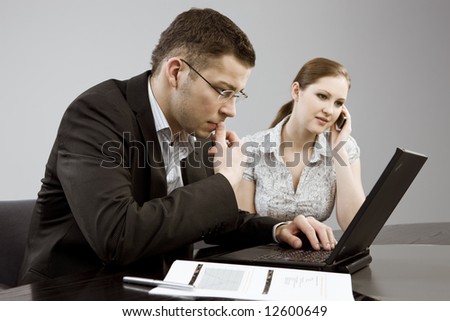 Business couple portrait - young man and woman working together