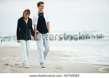 people walking on beach. stock photo : two young people