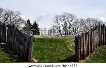 split rail fences leading the way up a grassy hill
