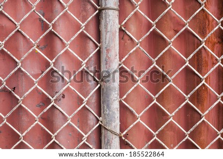 Wire Mesh and red corrugated fence  background