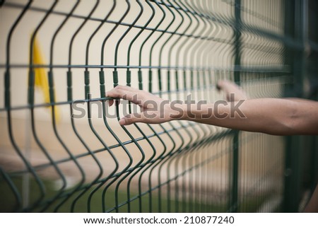 Hand girl in iron mesh