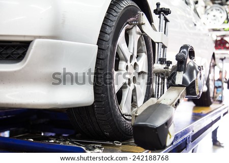 Closed up of an auto wheel that is undergoing wheel alignment