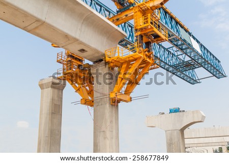 Construction of a mass transit train line in progress with heavy infrastructure. This photo shows the progress in joining the various blocks/modules of the line with heavy equipment.