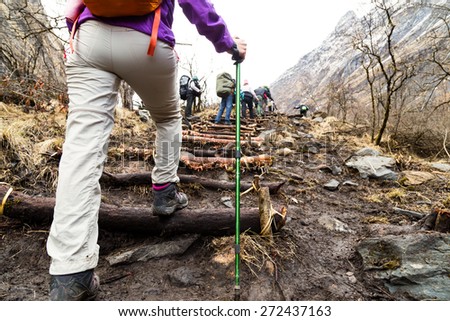 Female hiking up a mountain with a group of people