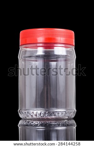 Translucent plastic PVC jar with red cover isolated in black