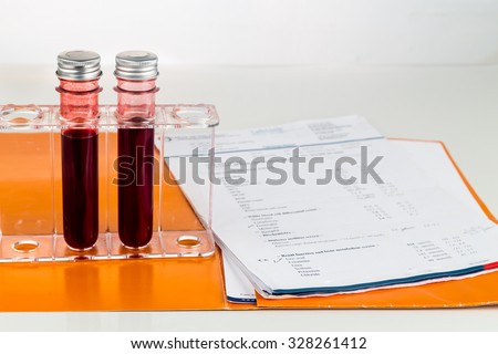 Blood sample in test tubes with health analysis screening report.
