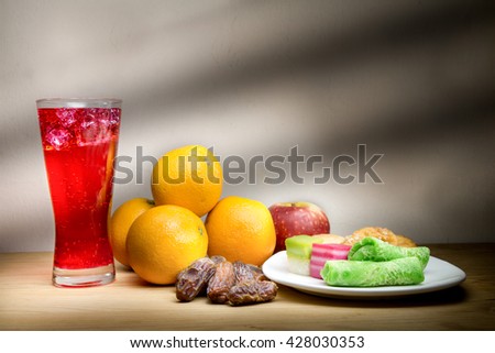 Cold refreshing syrup drinks, sweet dates, kuih are simple and common iftar break fast food during fasting month of Ramadan. Fine art rendition.