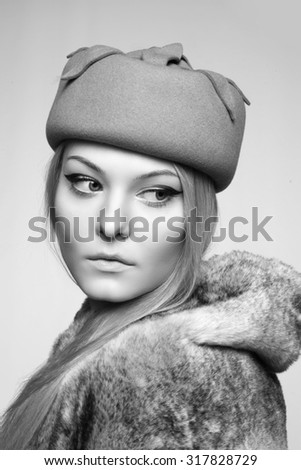 close portrait of beautiful blond woman in retro vintage style, hat and fur. copy space. black and white.