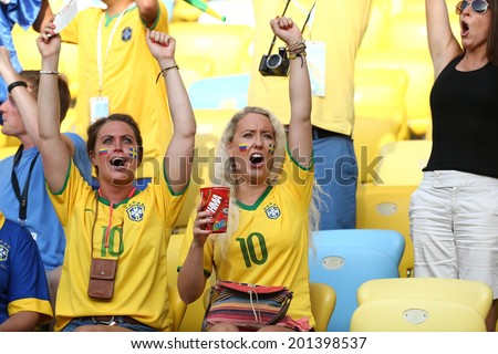 RIO DE JANEIRO, BRAZIL - June 28, 2014:  soccer fans celebrating at the 2014 World Cup Round of 16 game between Colombia and Uruguay at Maracana Stadium. No Use in Brazil.