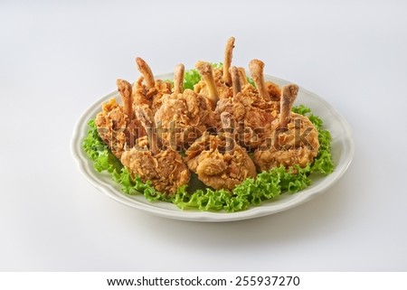 Fried chicken drum stick in plate shoot on clear background