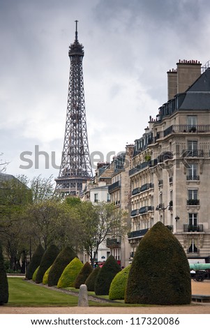 Spring in Paris. Street with a view to Eiffel Tower with dramatic sky. France