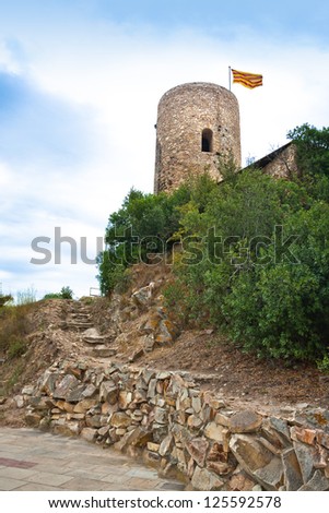St. John Castle Tower with the catalonian flag at the top, in Blanes. Costa Brava. Spain