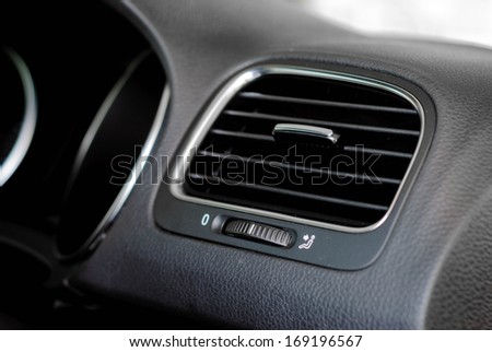 interior shot of modern car air vent with on/off switch