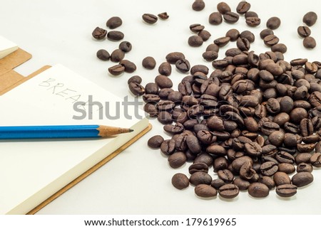 coffee break time with fresh coffee bean and notepad writen break on it