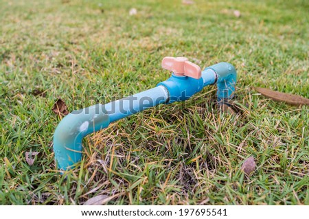 blue pipe with sprinkle switch in the garden
