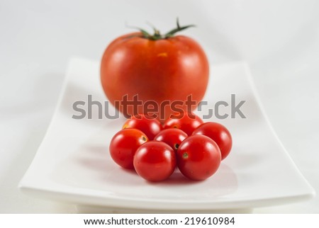 small and big tomatoes in white background