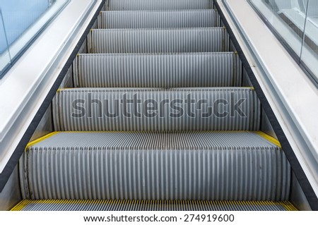 moving up in modern escalator in train station