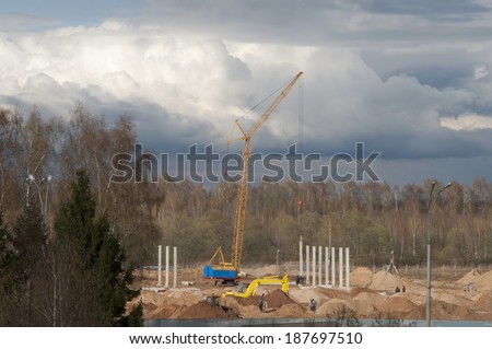 construction work near grove, beautiful sky before the rain