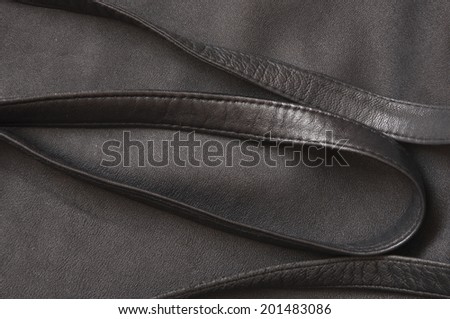 black leather texture background with leather straps