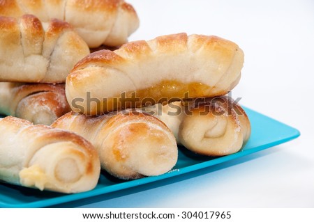 A bunch of sweet rolls on the blue plastic plate.