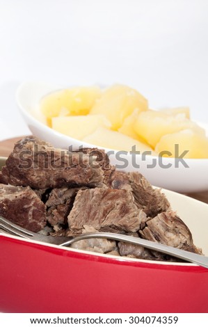 Boiled beef and boiled potatoes served in a bowl.