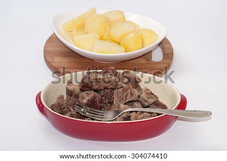 Boiled beef and boiled potatoes served in a bowl.