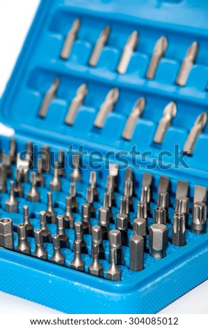 Set of metal bits in a blue plastic box.