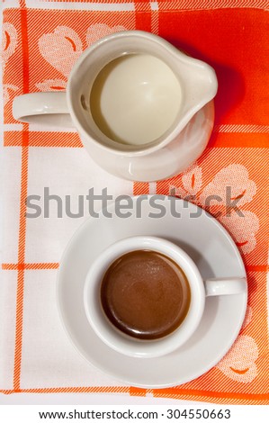 A cup of coffee and milk.