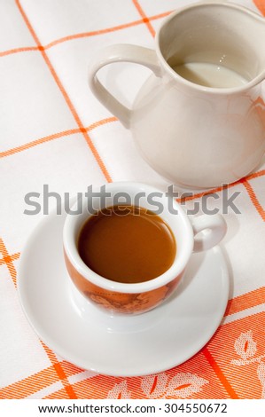 A cup of coffee and milk.