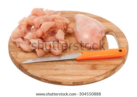 Chopped chicken white meat on the wooden board.