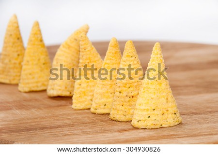 Salty snacks on the wooden board.