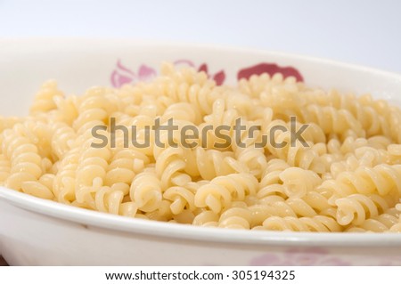 Cooked macaroni in a white bowl.