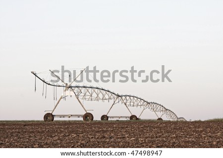 A center modern pivot irrigation system in a cultivated land farm field