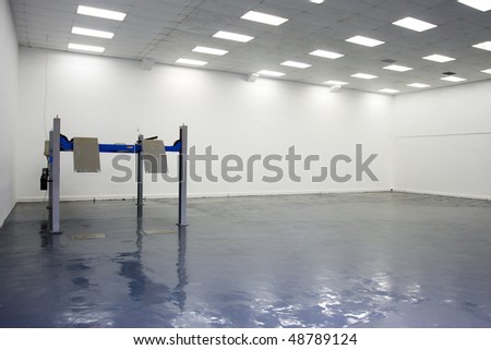 a single lift in car service garage with a blue floor (equipment for diagnostics of car)