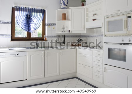 Classic kitchen with white wood and white tile
