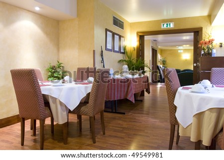 Elegant decorated dining room (Empty restaurant with set tables)