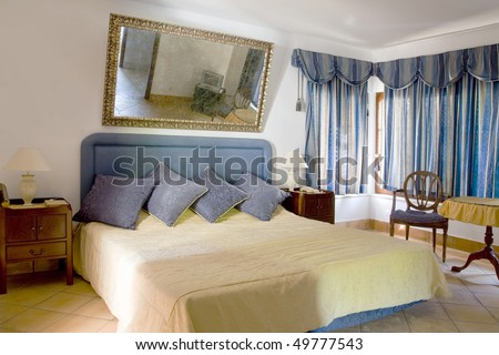Classical style and elegant decorated sleeping room (bedroom) with a big mirror