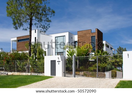 Street view of a beautiful villa with a healthy garden on a sunny day