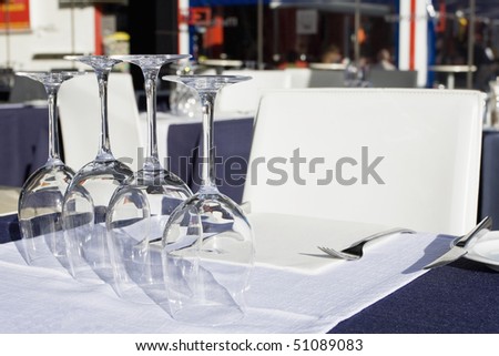 Table setting at a European michelin restaurant (Glasses of wine set on white dining table)