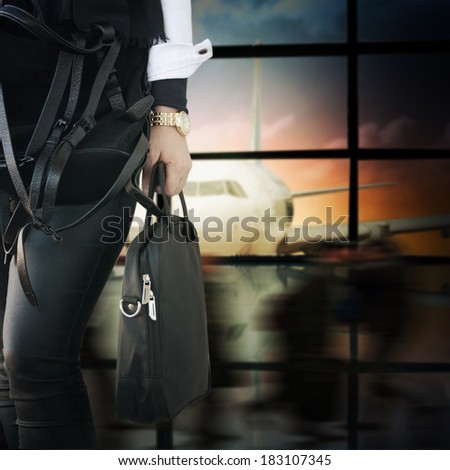 Woman with notebook bag in the airport
