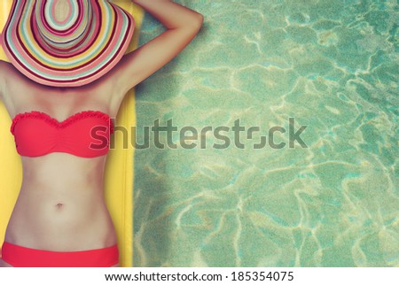 Woman relaxing on inflatable mattress in the sea