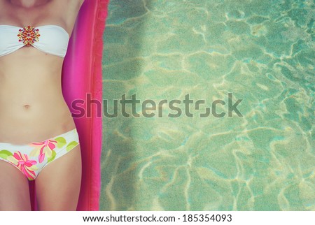 Woman relaxing on inflatable mattress in the sea