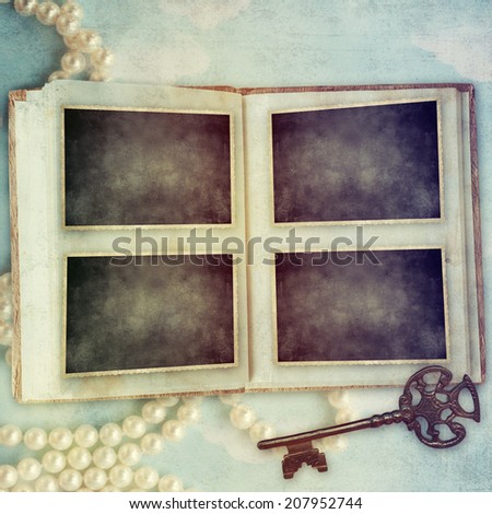 vintage camera and picture frame over wooden background
