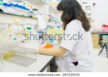 blurred image of scientists in the laboratory lsets PCR test micro tubes in a centrifuge