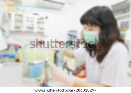 blurred image of research in laboratory. Scientist working with samples sets DNA test micro tubes in a centrifuge