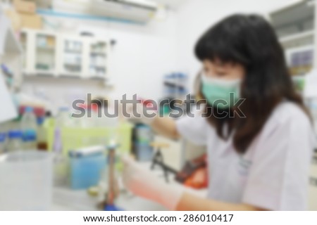 blurred image of research in laboratory. Scientist working with samples sets DNA test micro tubes in a centrifuge