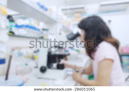 blurred image of research in laboratory. Scientist working with samples of DNA test into a test tube