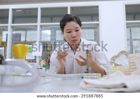 blurred image of Young female researcher in white coat Transplant infections samples in laboratory