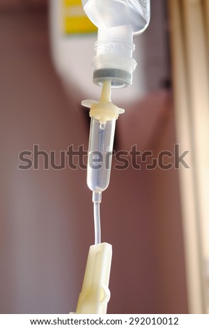 Close up saline IV drip for patient and Infusion pump in hospital.